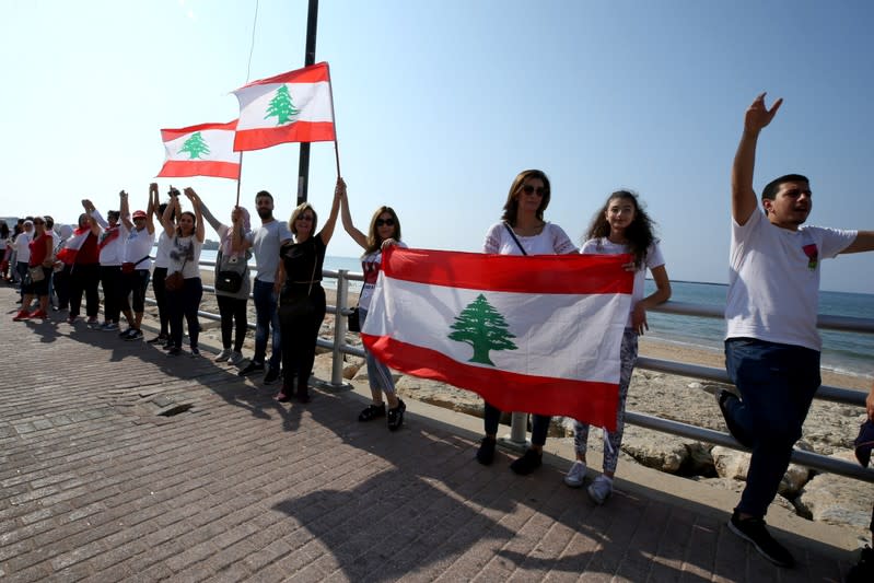 Demonstrators form a human chain during ongoing anti-government protests in Sidon