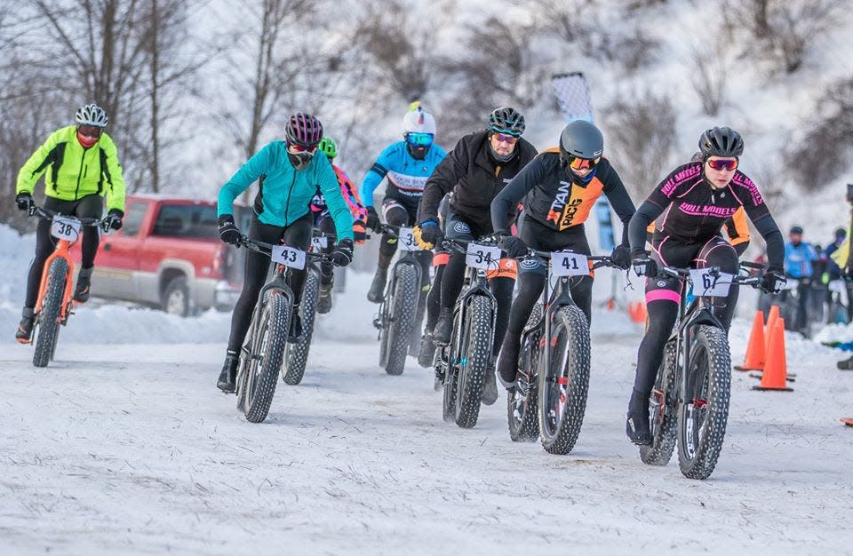 Cyclists charge through the half-mile course in a recent year's Frosted Fat Tire relay race at The Pit Fitness Ranch in Three Rivers, Mich.