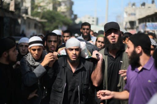 Palestinians carry the coffin of Salafist leader Hisham al-Saedini during his funeral procession at Al-Bureij refugee camp in the central Gaza Strip. Two Gazans died in an Israeli strike on Sunday, raising to five the total number killed as Israel pressed a series of raids targeting militants