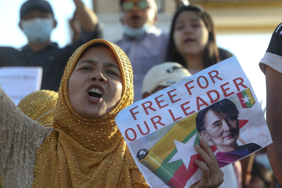 A demonstrator displays a placard calling for the release of detained Myanmar leader Aung San Suu Kyi during a protest in Mandalay, Myanmar, Wednesday, Feb. 10, 2021. Protesters continued to gather Wednesday morning in Mandalay breaching Myanmar's new military rulers' decrees that effectively banned peaceful public protests in the country's two biggest cities. (AP Photo)