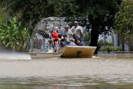 An airboat brings rescued residents to safety in Ascension Parish, Louisiana. REUTERS/Jonathan Bachman