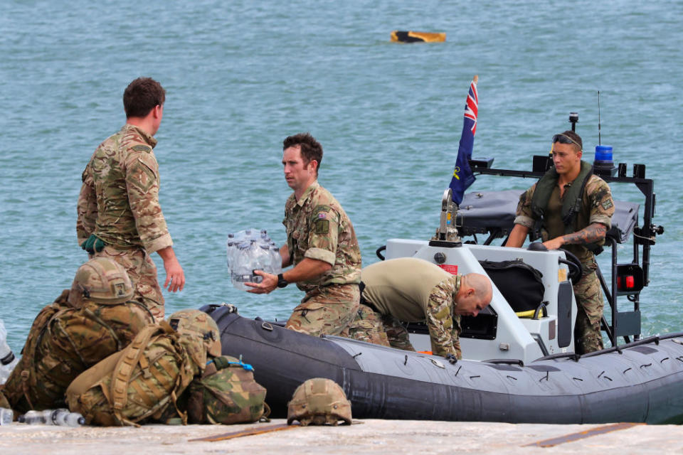 Members of the Humanitarian and Disaster Relief (HADR) team from The Royal Fleet Auxiliary ship Mounts Bay deliver aid to the Islanders of Great Abaco in The Bahamas on September 4, 2019. | AFP Photo / UK MOD / CROWN COPYRIGHT 2019