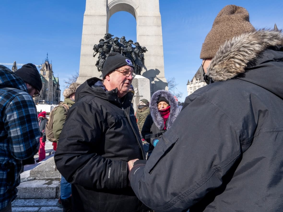 Independent MPP Randy Hillier greets anti-mandate protesters at the War Memorial in Ottawa on Feb. 13. Calls have emerged for Hillier's arrest after he urged protesters to disobey a request from Ottawa police that people not tie up their phone lines. (Frank Gunn/The Canadian Press - image credit)