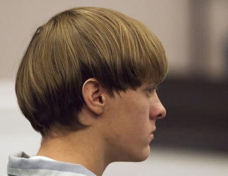 Dylann Roof, the 21-year-old man charged with murdering nine worshippers at a historic black church in Charleston last month, listens to the proceedings with assistant defense attorney William Maguire during a hearing at the Judicial Center in Charleston, South Carolina July 16, 2015. REUTERS/Randall Hill