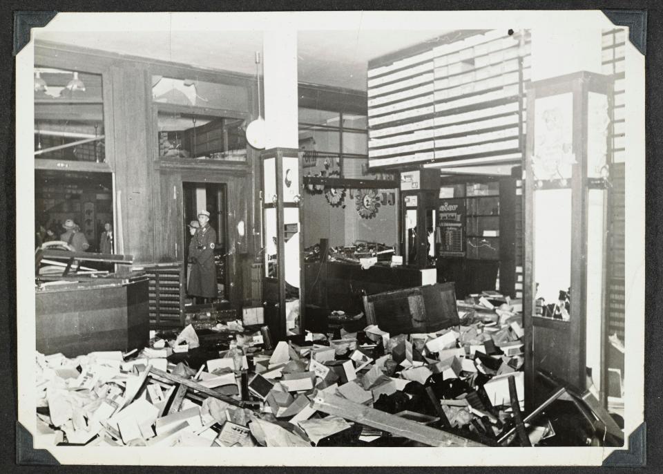 This photo released by Yad Vashem, World Holocaust Remembrance Center, shows German Nazis stand by ransacked Jewish property during Kristallnacht intake most likely in the town of Fuerth, Germany on Nov. 10, 1938