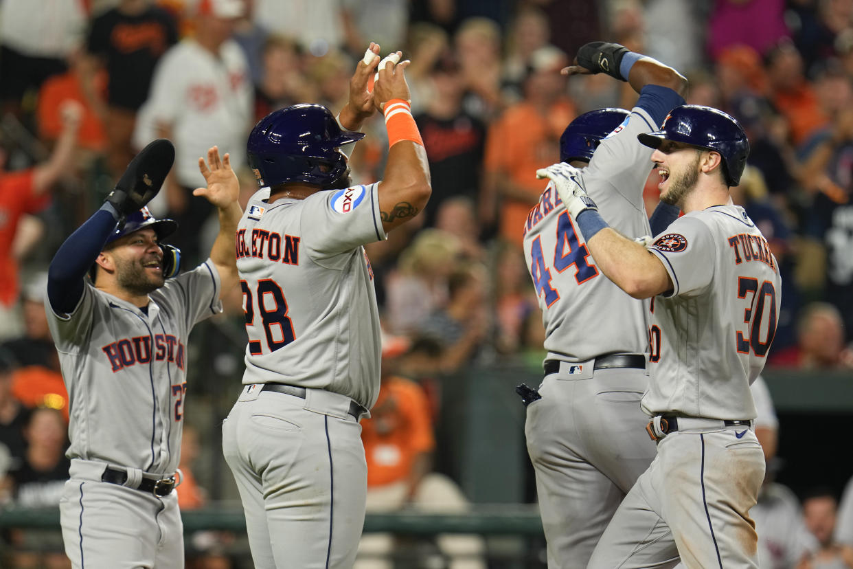 Houston Astros' Kyle Tucker, right, celebrates a ninth inning grand slam against the Orioles with Jose Altuve, left, Jon Singleton, second from left, and Yordan Alvarez (44). (AP Photo/Julio Cortez)