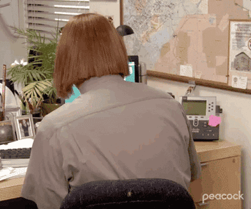 Dwight from "The Office" using Meredith's wig.