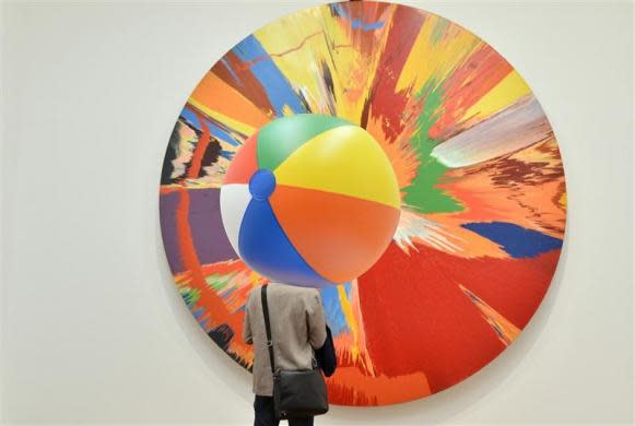 A visitor views a Spin Painting by British artist Damien Hirst at the Tate Modern gallery in London April 2, 2012. Hirst's retrospective show runs from April 4 to September 9.