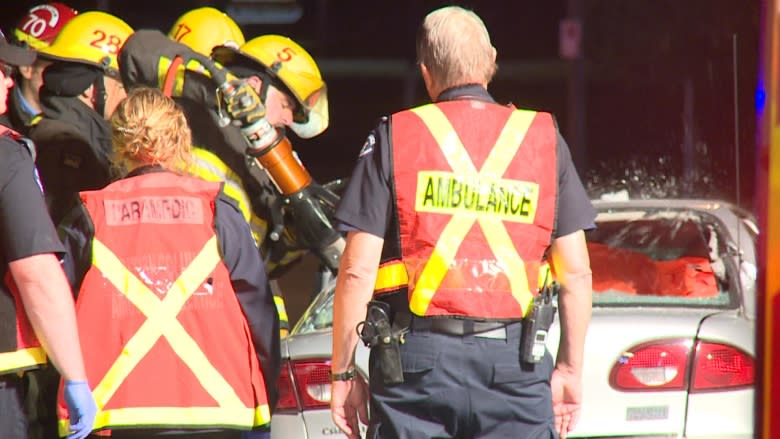 New Westminster crash traps woman in car