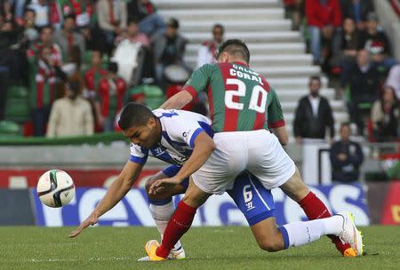 Porto's Casemiro (6) fights for the ball with Maritimo's Bruno Gallo during their Portuguese premier league soccer match at Barreiros stadium in Funchal January 25, 2015. REUTERS/Duarte Sa