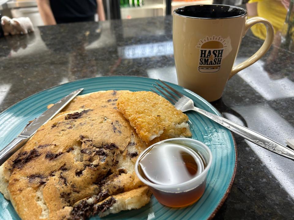 Chocolate chip pancakes and a hash brown come with your choice of breakfast meat at Hash N Smash.