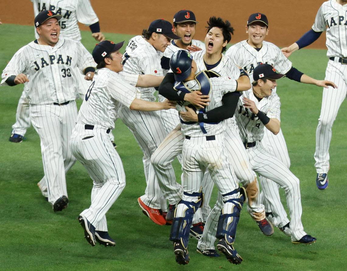 Japan pitcher Shohei Ohtani (16) and catcher Yuhei Nakamura (27) celebrate on the field with teammates after defeating the United States during the World Baseball Classic Championship Game at loanDepot Park in Miami, Fla. on Tuesday, March 21, 2023.