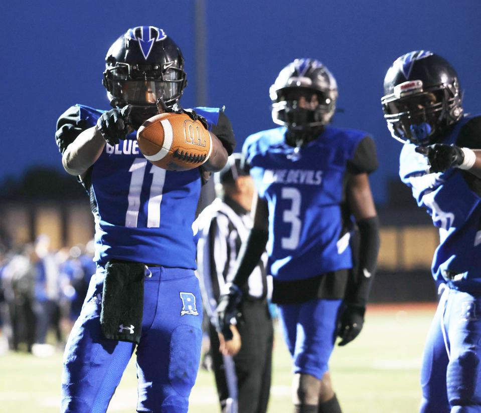 Randolph running back Osaruyi "Greg" Izedonmwen, left, scores a touchdown with teammates from left, Makhi Barnes, and Vidinic Bembeleeza, during a game versus Hull on Friday, Sept. 30, 2022.