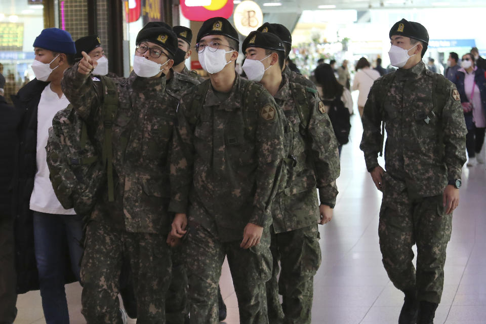 Army soldiers wearing face masks to help protect against the spread of the coronavirus arrive to board a train at the Seoul Railway Station in Seoul, South Korea, Tuesday, Nov. 3, 2020. (AP Photo/Ahn Young-joon)