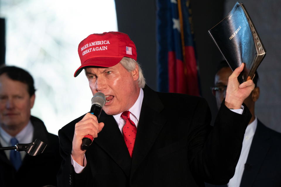 Attorney L. Lin Wood holds up a Bible while speaking during a press conference on election results in Alpharetta, Georgia, U.S., December 2, 2020.  REUTERS/Elijah Nouvelage