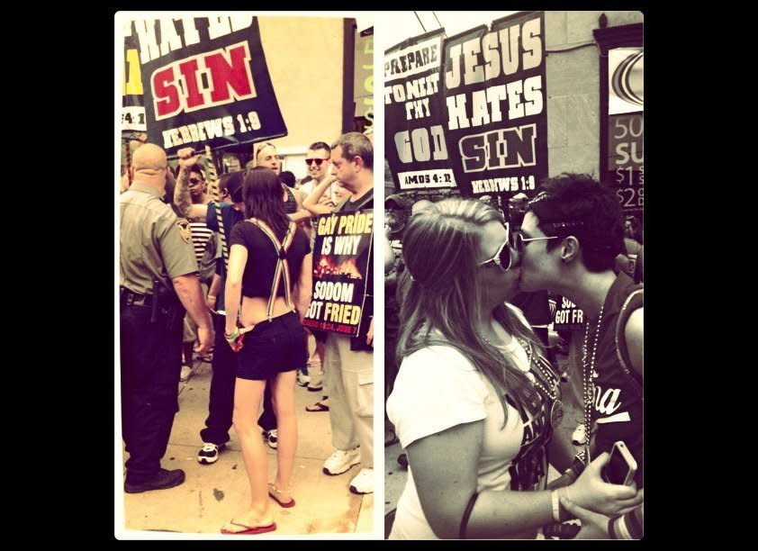 From Keli Stooksberry: The picture on the right is my friend Courtney talking to protesters. The picture on the left is of my partner DeAnna and I kissing in front of the protesters.  This was my second pride and the first interaction with protesters. I was not surprised but still overwhelmed by their presence in such a wonderful and uplifting celebration. My friend Courtney had one of them speechless by the end of their conversation not by throwing obscenities his way but rather using her knowledge of scripture. Again, I was not surprised that the man she spoke with had no more knowledge of the bible than the words written on his sign but it was priceless to see him have nothing left to say because Courtney was right! 