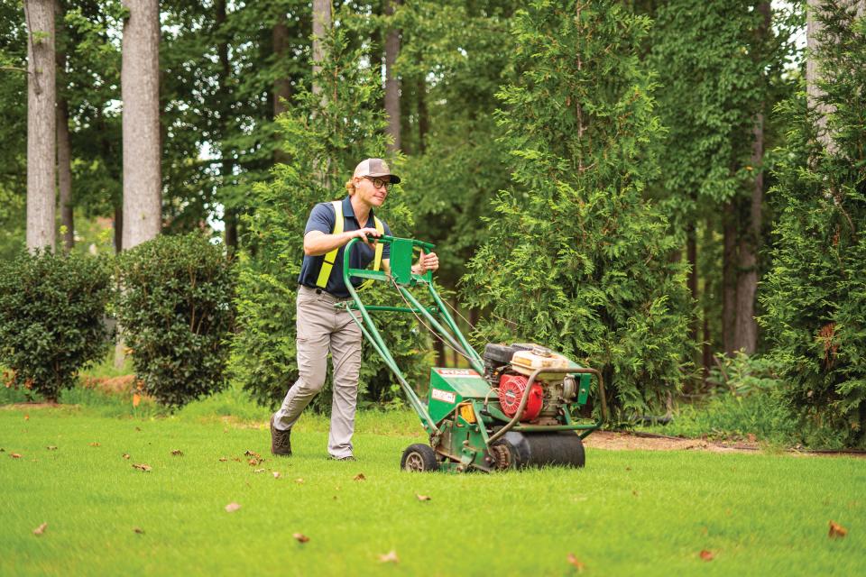 Grass Nerds technicians – decked out in trademark glasses and suspenders – fertilize, apply weed control and pesticides, and aerate their clients' yards.