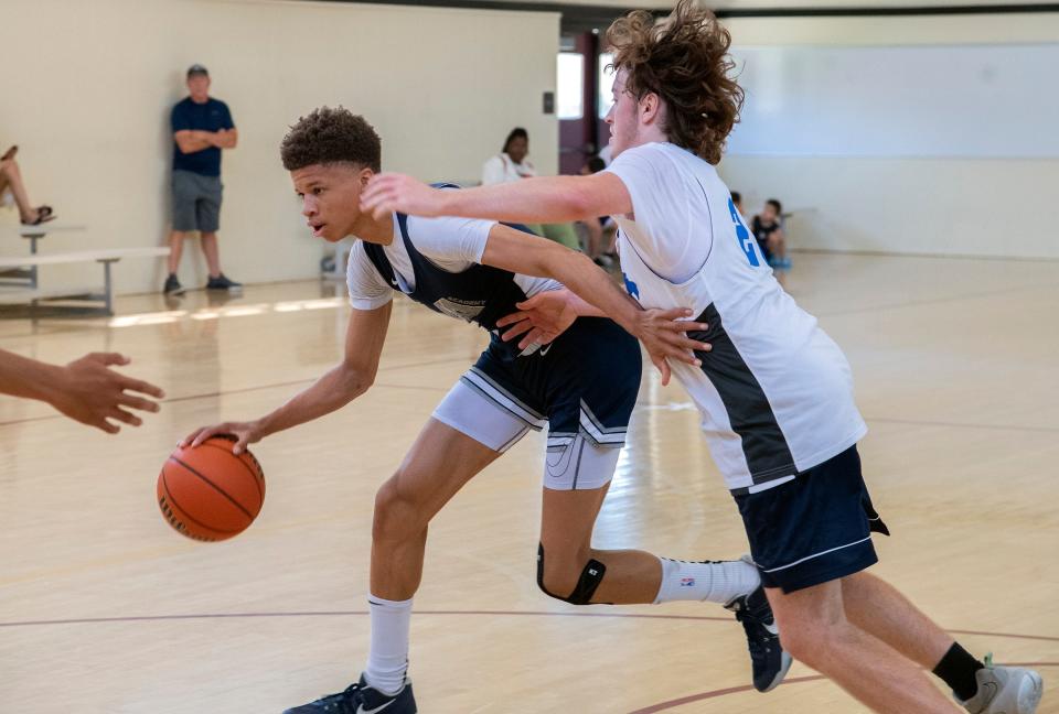 Venture Academy's Mario Williams Jr., left, drives on Sierra's Tim Sarginson during a game of the Modesto Christian basketball tournament at Edison High School in Stockton on Friday, June 9, 2023.