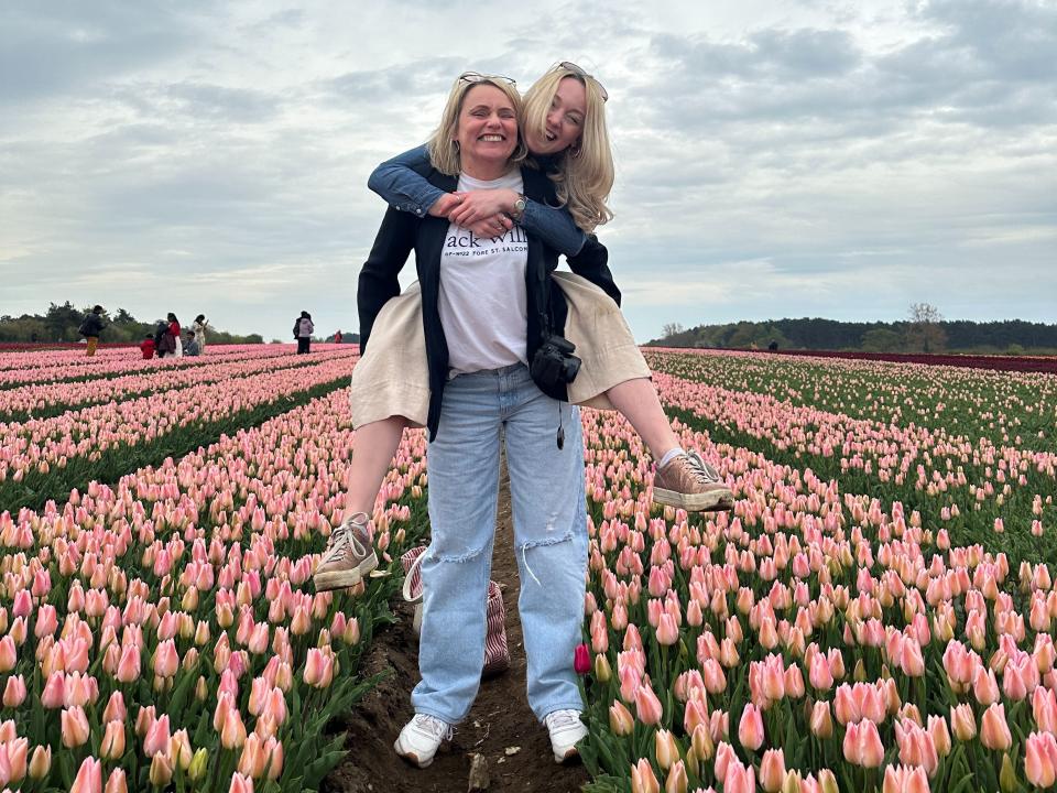 Mom and daughter posing with flowers