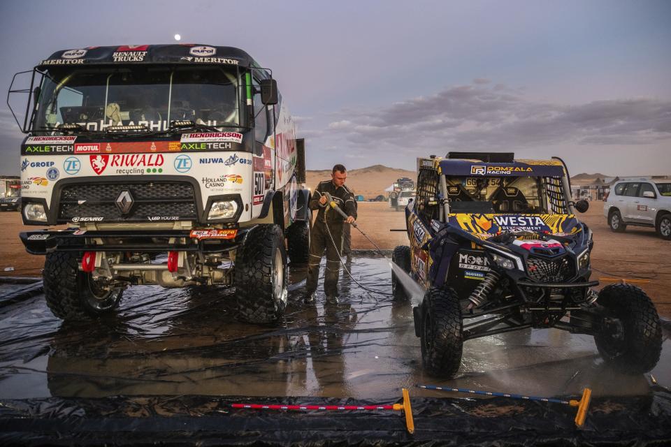 In this Thursday, Jan. 9, 2020 photo, a competitor washes a Can-Am SSV after stage five of the Dakar Rally in Hail, Saudi Arabia. Formerly known as the Paris-Dakar Rally, the race was created by Thierry Sabine after he got lost in the Libyan desert in 1977. Until 2008, the rallies raced across Africa, but threats in Mauritania led organizers to cancel that year's event and move it to South America. It has now shifted to Saudi Arabia. The race started on Jan. 5 with 560 drivers and co-drivers, some on motorbikes, others in cars or in trucks. Only 41 are taking part in the Original category. (AP Photo/Bernat Armangue)