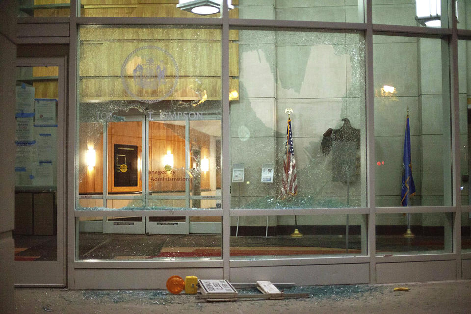 The windows of the Tommy G. Thompson Center on Public Leadership in Madison, Wis. are shattered during demonstrations Tuesday, June 23, 2020. Crowds outside the Wisconsin State Capitol tore down two statues and attacked a state senator amid protests following the arrest of a Black man who shouted at restaurant customers through a megaphone while carrying a baseball bat. (Emily Hamer/Wisconsin State Journal via AP)