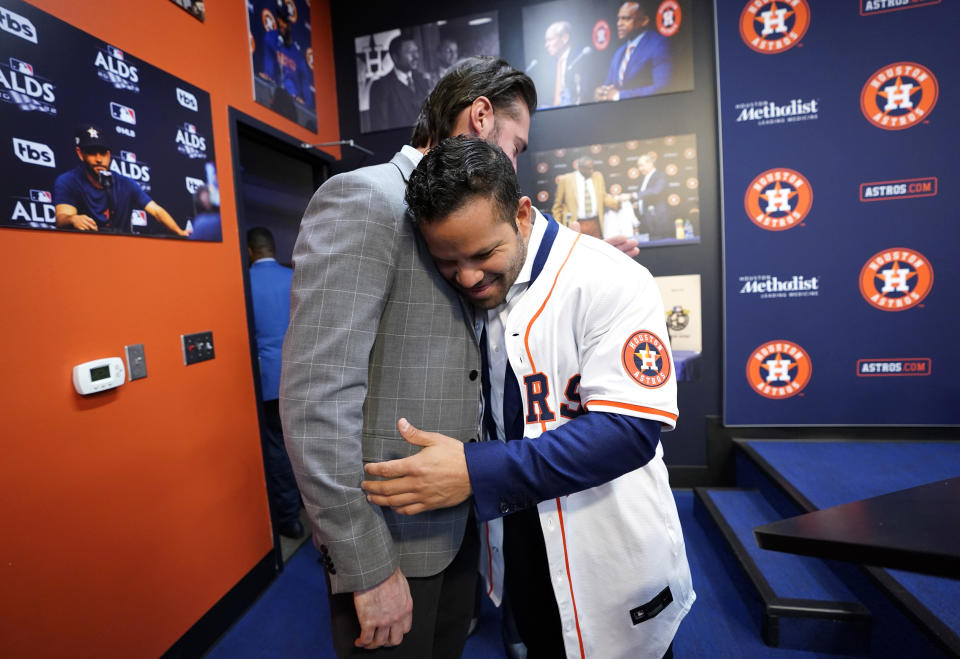 Houston Astros Jose Altuve, right, gets a hug from Steve Grande after a press conference announcing they agreed to a five-year contract extension for him at Minute Maid Park on Wednesday, Feb. 7, 2024, in Houston. (Karen Warren/Houston Chronicle via AP)