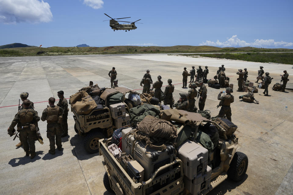 U.S. and Philippine troopers prepare to board a U.S. Army CH-47 helicopter at the airport at the Philippines' northernmost town of Itbayat, Batanes province during a joint military exercise on Monday, May 6, 2024. American and Filipino marines held annual combat-readiness exercises called Balikatan, Tagalog for shoulder-to-shoulder, in a show of allied battle readiness in the Philippines' northernmost island town of Itbayat along the strategic Bashi Channel off southern Taiwan. (AP Photo/Aaron Favila)