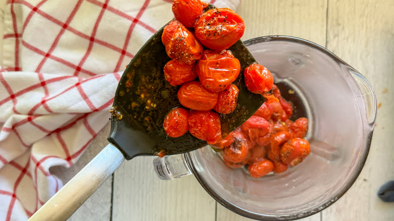 adding roasted tomatoes to blender