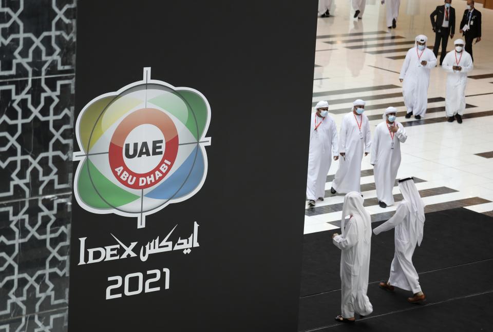 Visitors and officials arrive for the opening day of the International Defence Exhibition & Conference, IDEX, in Abu Dhabi, United Arab Emirates, Sunday, Feb. 21, 2021. (AP Photo/Kamran Jebreili)