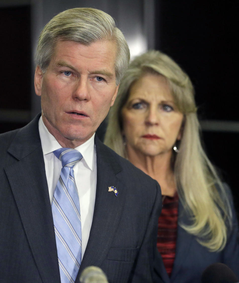 Former Virginia Gov. Bob McDonnell makes a statement as his wife, Maureen, listens during a news conference in Richmond, Va., Tuesday, Jan. 21, 2014. McDonnell and his wife were indicted Tuesday on corruption charges after a monthslong federal investigation into gifts the Republican received from a political donor. (AP Photo/Steve Helber)