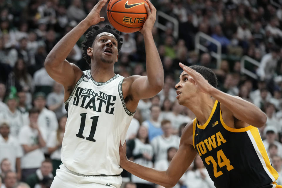 Michigan State guard A.J. Hoggard (11) attempts a layup as Iowa forward Kris Murray (24) defends during the second half of an NCAA college basketball game, Thursday, Jan. 26, 2023, in East Lansing, Mich. (AP Photo/Carlos Osorio)