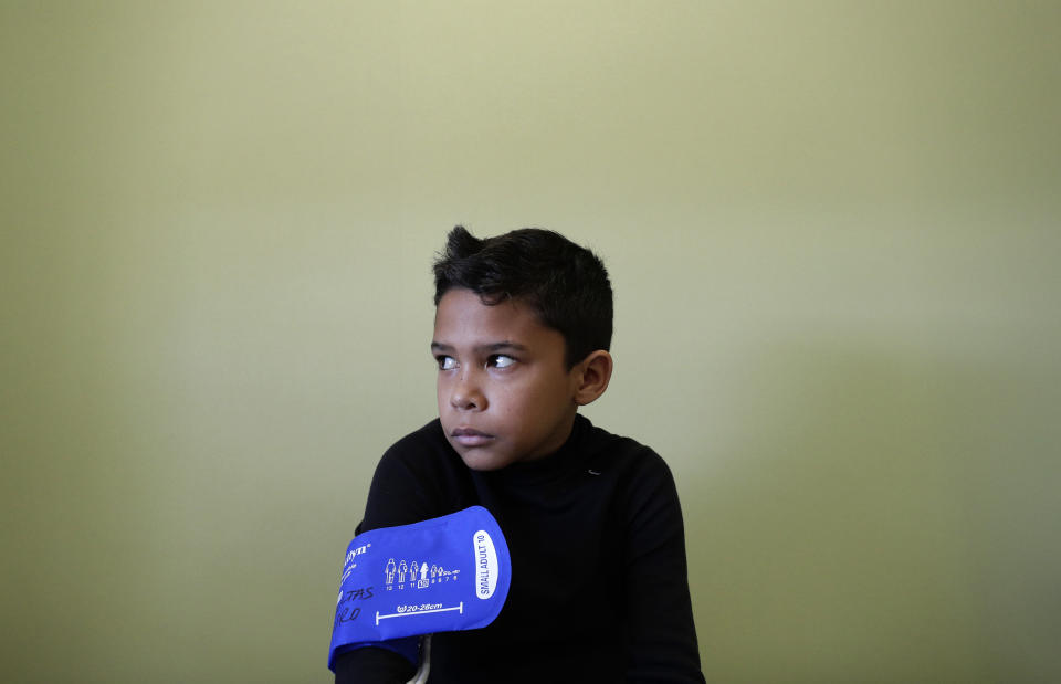 In this Friday, Feb. 22, 2019 photo, Hector Castillo, 11, from Venezuela, waits before a medical check at the Sant Joan de Deu hospital in Barcelona, Spain. 11-year-old Hector Castillo with at least eight other severely ill children, became the unintended victims of U.S. sanctions against companies tied to the embattled government of Venezuelan leader Nicolas Maduro. Hector suffers from Sickle Cell disease, a disorder that affects hemoglobin, the molecule in red blood cells that delivers oxygen to cells throughout the body. (AP Photo/Manu Fernandez)