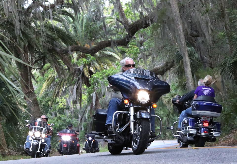 Riders snake their way through the winding High Bridge Road of the loop, passing under the moss-covered oaks and palms during Bike Week in 2023. It's a popular ride to get away from the noise and crowds on Main Street and other hot spots.