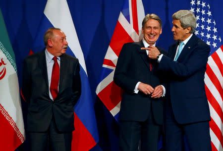 Alexey Karpov, the deputy director of the Department for Nonproliferation and Arms Control of the Ministry of Foreign Affairs of Russia, British Foreign Secretary Philip Hammond and U.S. Secretary of State John Kerry (L-R) discuss before a joint statement of EU foreign policy chief Federica Mogherini and Iran's Foreign Minister Javad Zarif in Lausanne April 2, 2015. REUTERS/Ruben Sprich