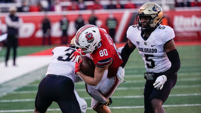 Utah tight end Brant Kuithe (80) get tackled by Colorado cornerback Christian Gonzalez at Rice-Eccles Stadium in Salt Lake City on Friday, Nov. 26, 2021. The two teams will meet again at Rice-Eccles Stadium Saturday in what will be the final Pac-12 football contest ever at the stadium.