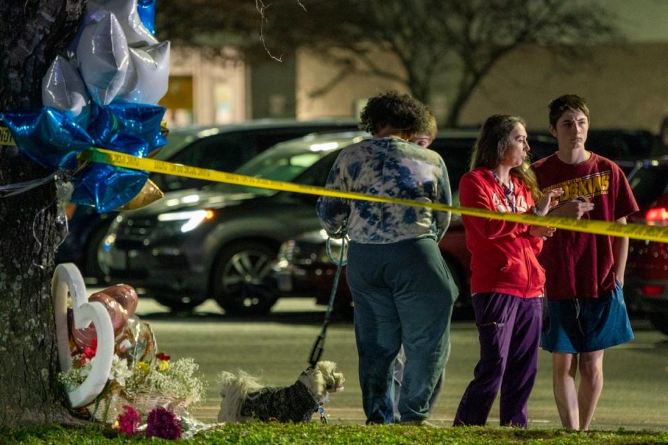 A group gathers near a makeshift memorial outside a Walmart in Virginia where an employee killed six people (EPA)