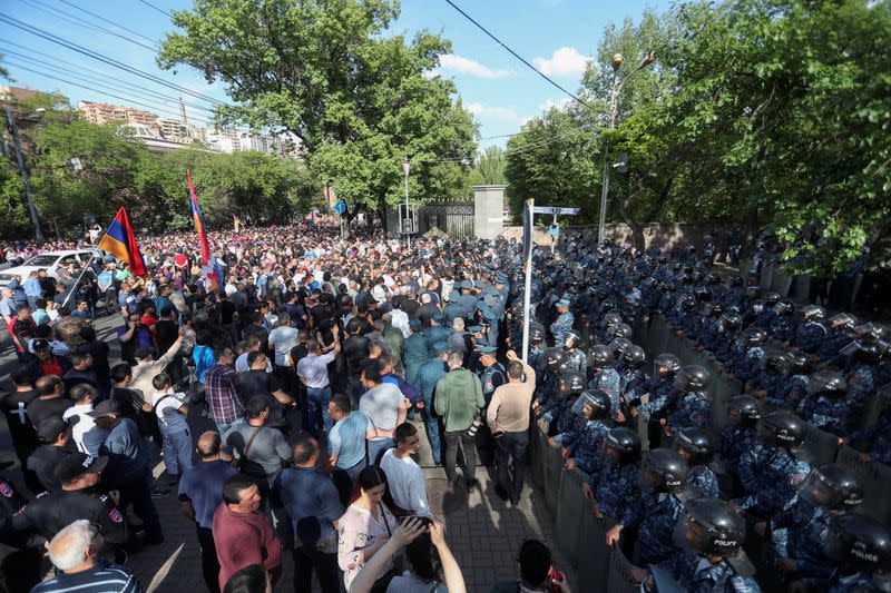 Police officers stand guard during an anti-government protest in Yerevan