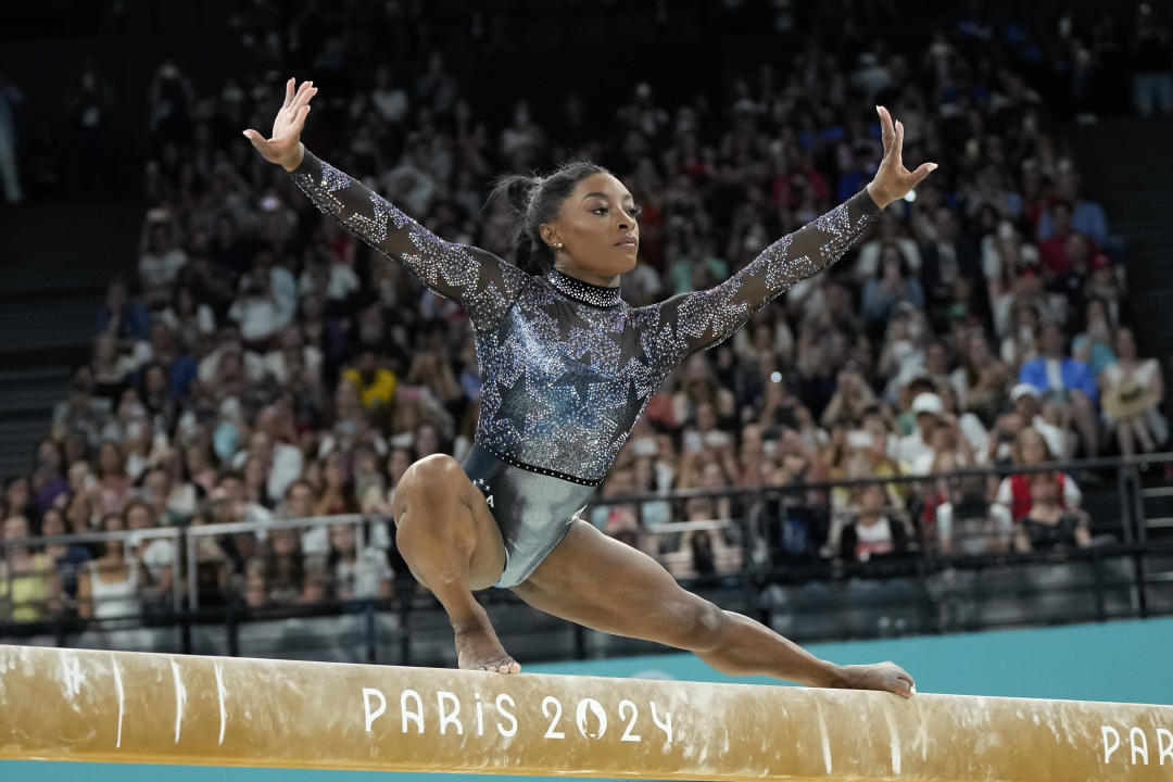 Simone Biles of the United States competes on the balance beam during a women's artistic gymnastics qualification round at the 2024 Summer Olympics, Sunday, July 28, 2024, in Paris, France. (AP Photo/Charlie Riedel)