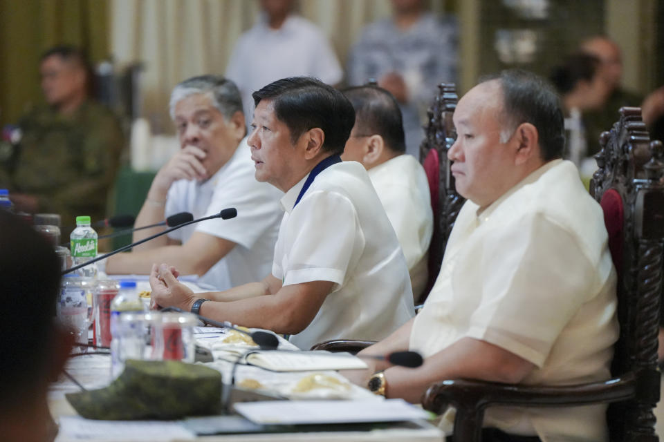 In this handout photo provided by the Malacanang Presidential Communications Office, Philippine President Ferdinand Marcos Jr., center, talks beside Defense Secretary Gilberto Teodoro, right, during a conference at Camp Aguinaldo military headquarters in Quezon City, Philippines on Thursday July 4, 2024. Philippine forces would defend themselves with "the same level of force" if they come under assault again from China's coast guard in the disputed South China Sea where Chinese personnel armed with machetes and spears injured Filipino navy men and damaged two of their boats in a chaotic faceoff last month, the Philippine military chief warned Thursday. (Malacanang Presidential Communications Office via AP)