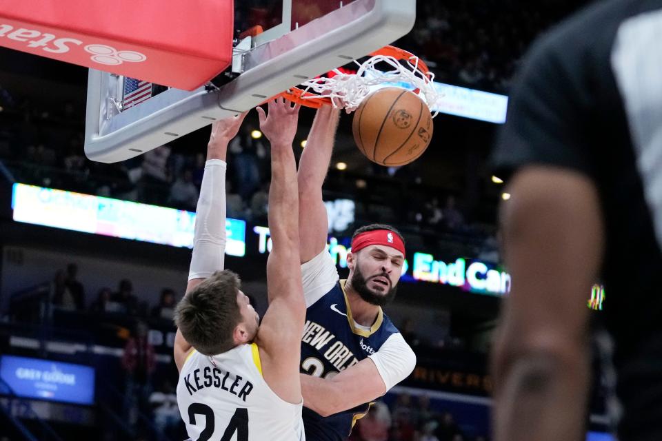 New Orleans Pelicans forward Larry Nance Jr. (22) slam dunks over Utah Jazz center Walker Kessler (24) in the second half of an NBA basketball game in New Orleans, Thursday, Dec. 28, 2023. The Pelicans won 112-105. (AP Photo/Gerald Herbert)