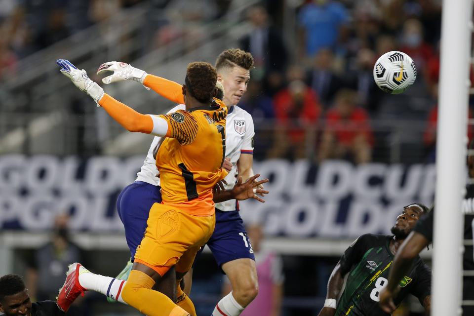 Jamaica goalkeeper Andre Blake (1) is unable to stop a header by United States forward Matthew Hoppe, center right, for a score as defender Oniel Fisher (8) looks on late in the second half of a CONCACAF Gold Cup quarterfinals soccer match, Sunday, July 25, 2021, in Arlington, Texas. (AP Photo/Brandon Wade)