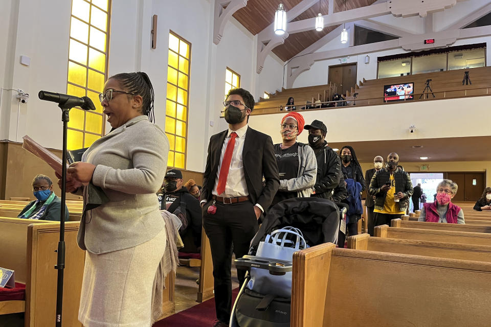 People line up to speak during a reparations task force meeting at Third Baptist Church in San Francisco, Wednesday, April 13, 2022. California's first-in-the-nation reparations task force met for the first time since its inaugural meeting nearly a year ago. The live meeting also comes mere weeks after the group voted to limit restitution to descendants of enslaved or free Black people in the U.S. before the 20th century. (AP Photo/Janie Har)
