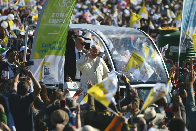 Pope Francis waves from the popemobile as he arrives at Maquehue airport in Temuco to celebrate an open-air mass