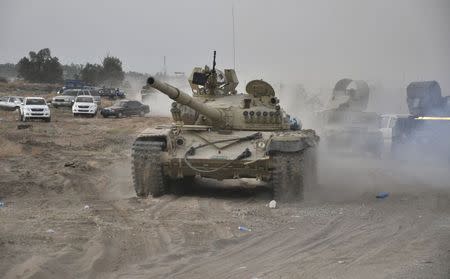 A tank is pictured as Iraqi security forces patrol after clashes with militants of the Islamic State, formerly known as the Islamic State in Iraq and the Levant (ISIL), in the Hamrin mountains in Diyala province July 16, 2014. REUTERS/Stringer