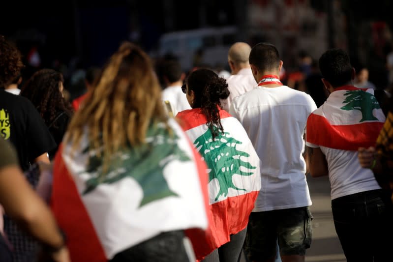 Protesters carrying Lebanese flags leave after a demonstration organised by students during ongoing anti-government protests in Beirut