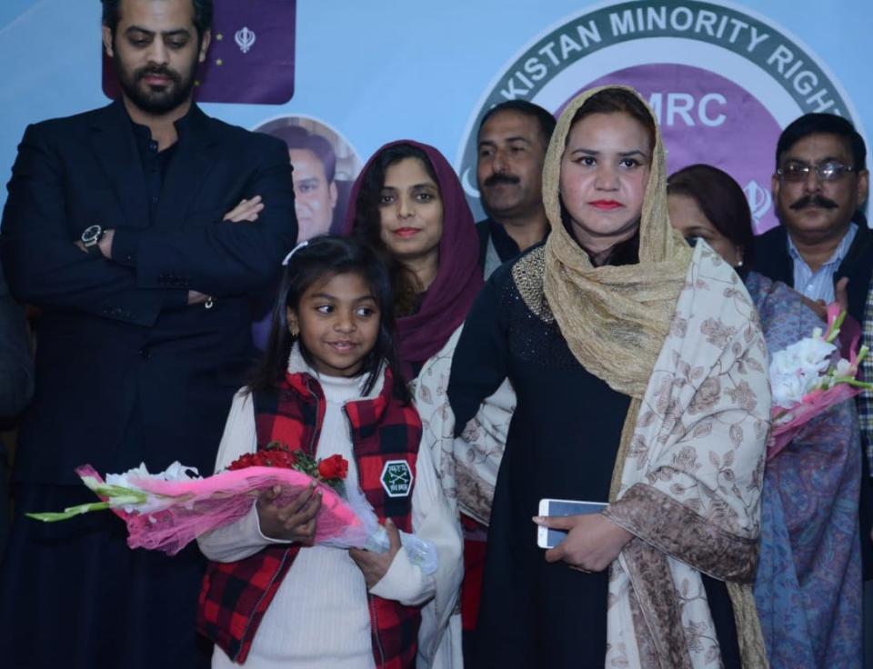 Imsaal "Cherry" Saqib, in front holding flowers, represented her father in Pakistan at events organized by the Pakistan Minority Rights Council, a group Junaid Saqib founded. Cherry, now 11, has been reunited with her father in Lakeland.