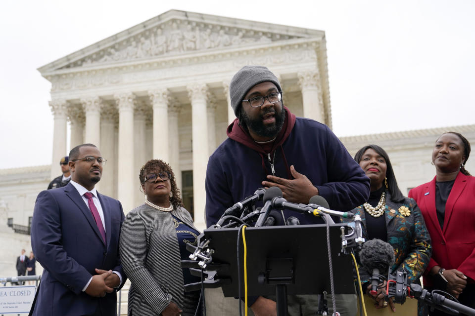 FILE - Evan Milligan, center, plaintiff in Merrill v. Milligan, an Alabama redistricting case that could have far-reaching effects on minority voting power across the United States, speaks with reporters following oral arguments at the Supreme Court in Washington, Oct. 4, 2022. Alabama lawmakers convene Monday, July 17, 2023 to draw a new congressional map. The directive comes after the U.S. Supreme Court ruling that affirmed the lower court’s ruling that Alabama’s existing congressional map — with a single Black district — likely violated the Voting Rights Act. (AP Photo/Patrick Semansky, File)