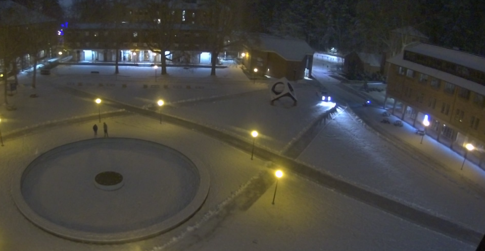 Two people are shown on a camera overlooking Fisher Fountain at Red Square on the Western Washington University campus about 4:15 a.m. Wednesday. Walkways across campus had been plowed through several inches of new snow.