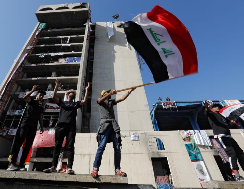 Demonstrators gesture as they take part in ongoing anti-government protests in Baghdad