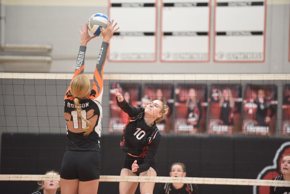 Addison's Kahlen Wheaton (10) swings for a kill while Hudson's Lauren Hill stretches out to try and block during a match in the 2022 season.